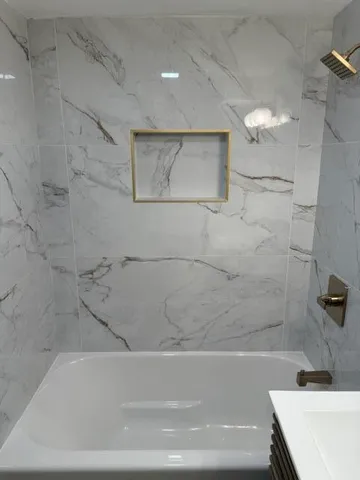 a bathroom with a bathtub and shower