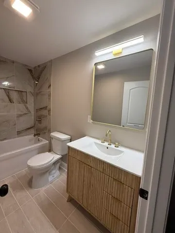 a bathroom with a double vanity sink toilet and a mirror