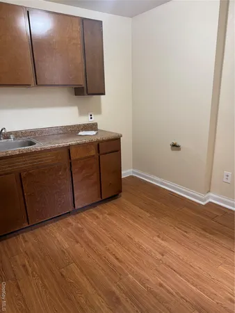 a room with granite countertop cabinets and sink
