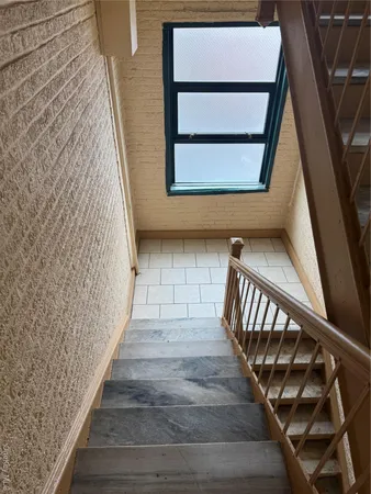 a view of staircase with wooden floor and a window