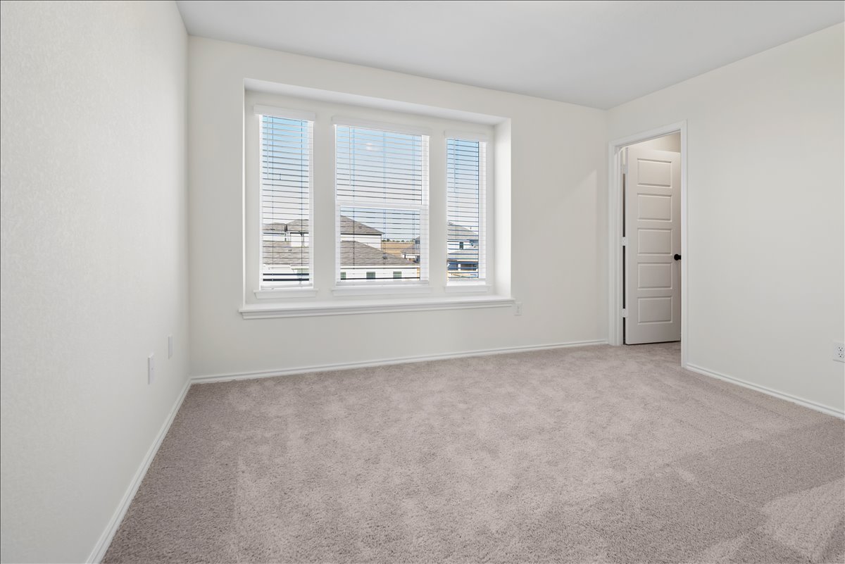 18501 Spotted Eagle Lane Elgin, TX 78621 - Photo 18 of 40 A quiet retreat with plush carpeting and abundant natural illumination from a wide window.