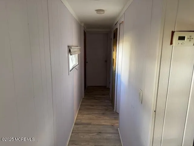 a view of a hallway with wooden floor