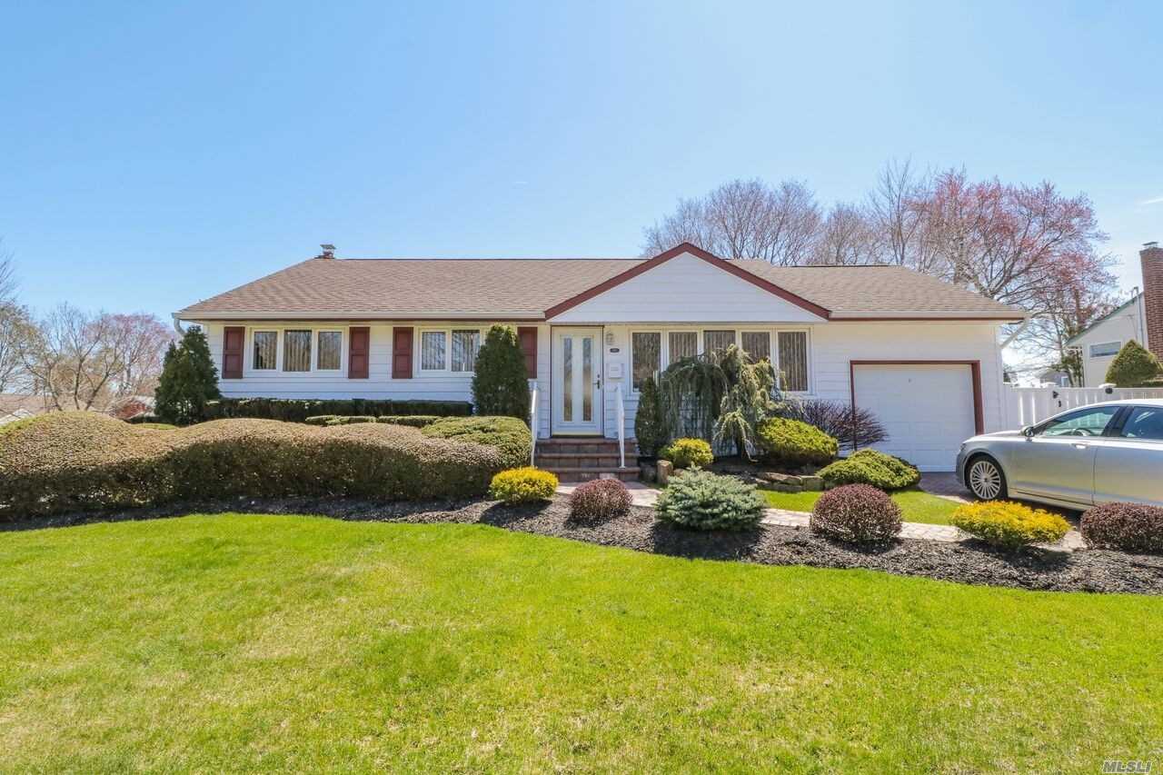 1 Colonial Road Old Bethpage, NY 11804 - Photo 1 of 1 a view of a house with backyard sitting area and swimming pool