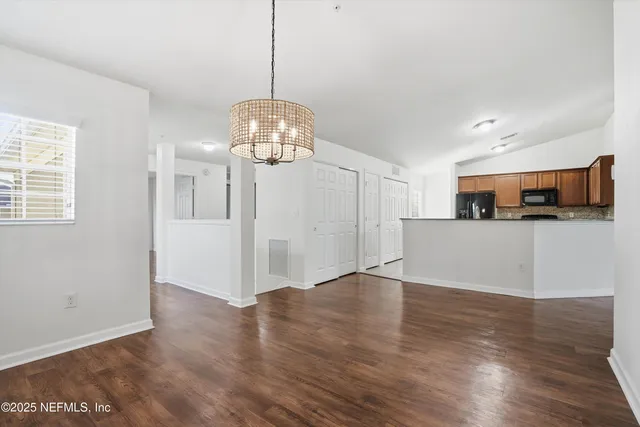 a view of a big room with wooden floor and a ceiling fan