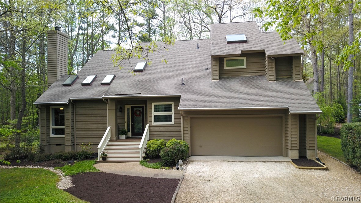14102 Spring Gate Road Midlothian, VA 23112 - Photo 3 of 19 a front view of a house with garage