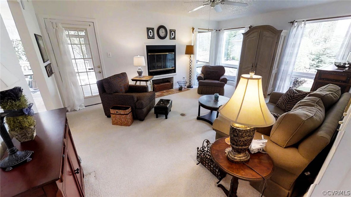 14102 Spring Gate Road Midlothian, VA 23112 - Photo 6 of 19 a living room with furniture fireplace and a large window