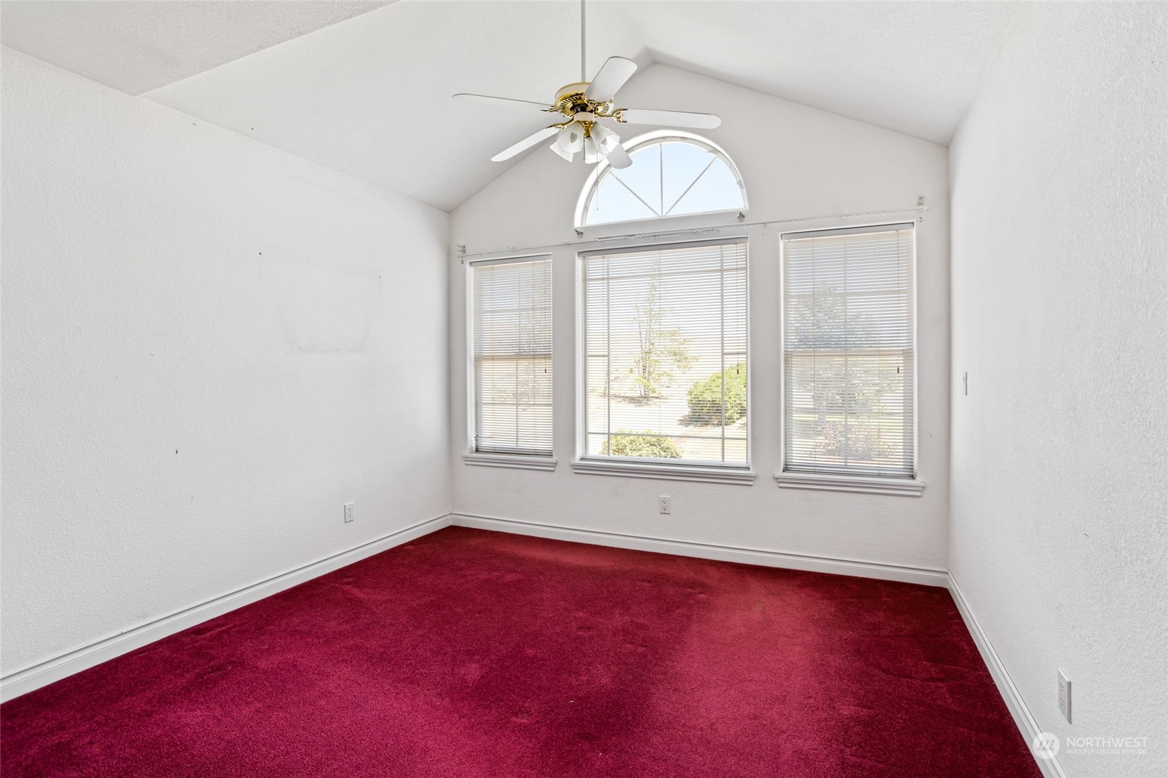 830 St Hilaire Road Yakima, WA 98901 - Photo 21 of 39 an empty room with a chandelier fan and windows