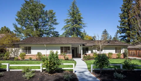 a front view of a house with garden and porch
