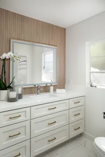 a bathroom with a sink a vanity and mirror