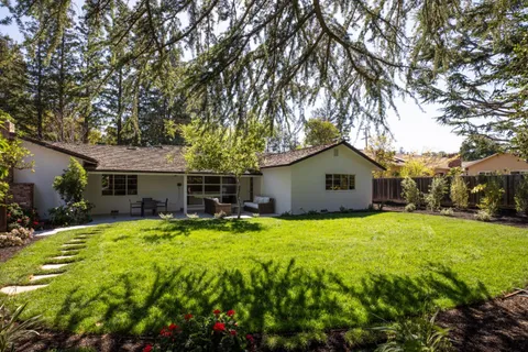 a house view with a sitting space and garden