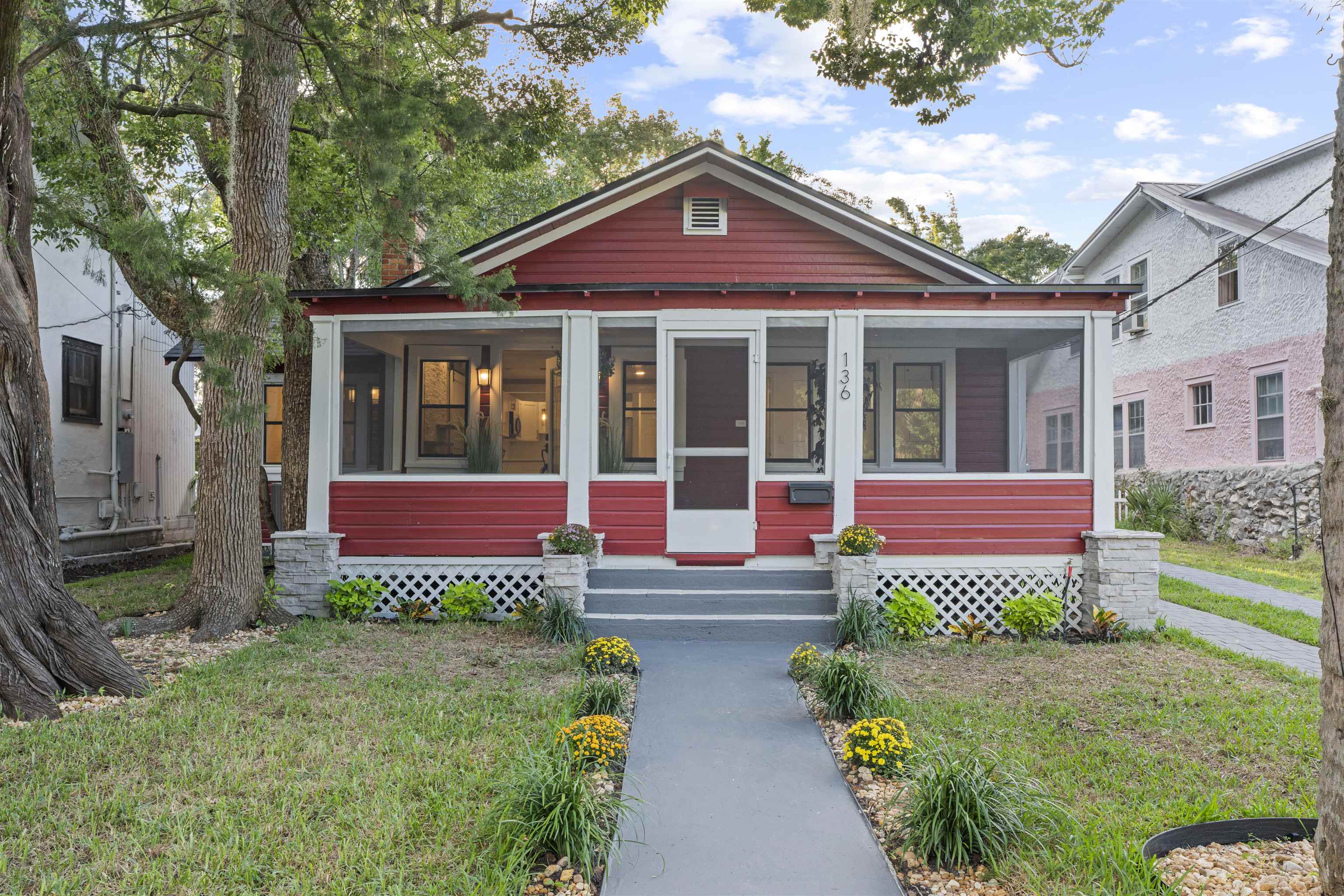 a front view of a house with a garden