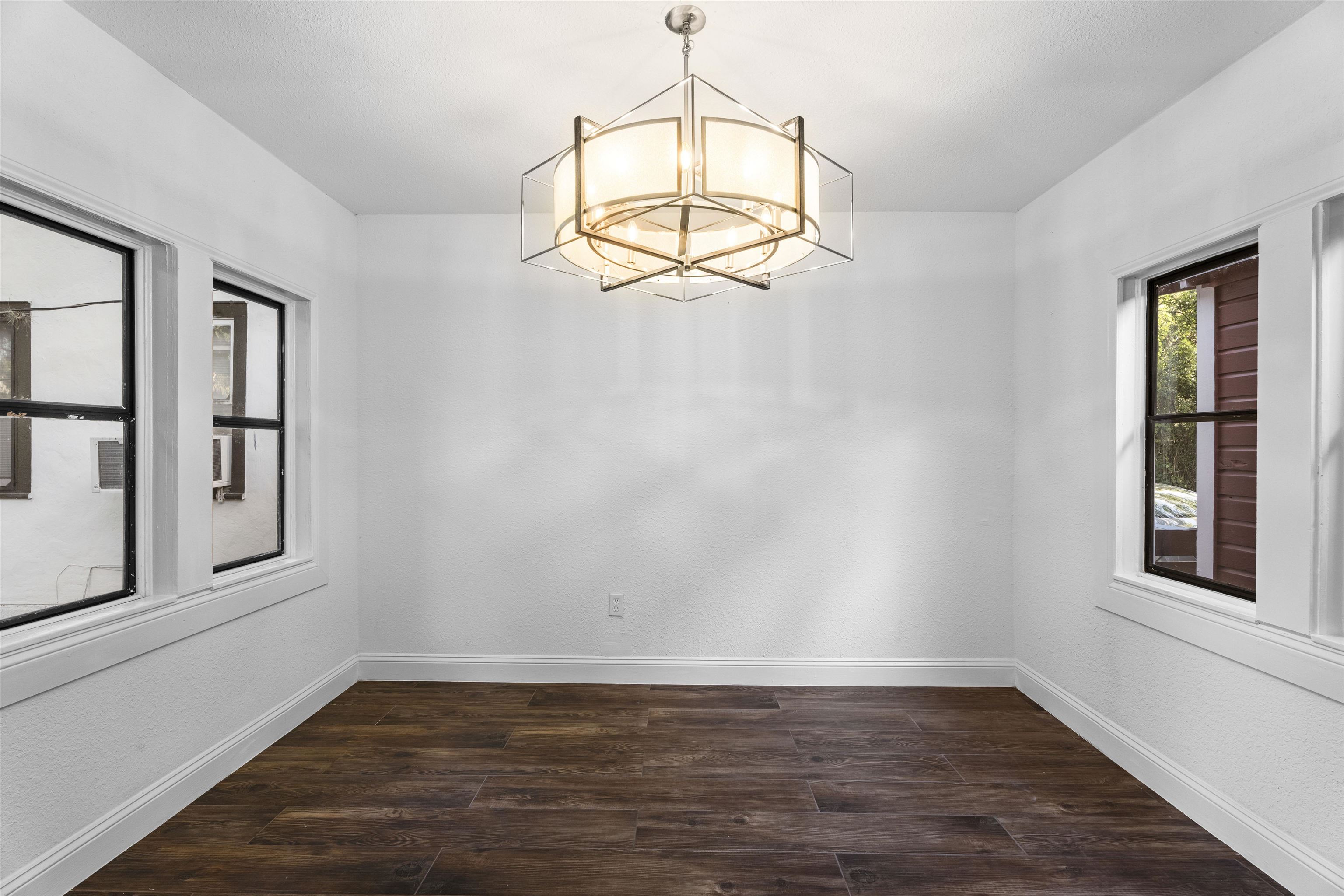 136 Washington Street St. Augustine, FL 32084 - Photo 12 of 50 an empty room with wooden floor cabinet and windows