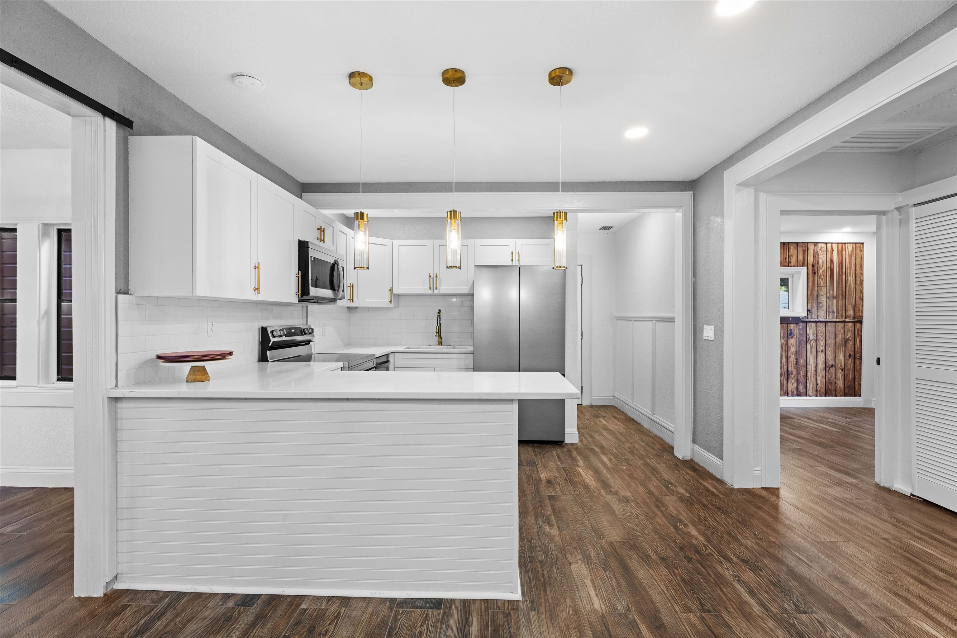 136 Washington Street St. Augustine, FL 32084 - Photo 14 of 50 a kitchen with stainless steel appliances a refrigerator and a stove top oven