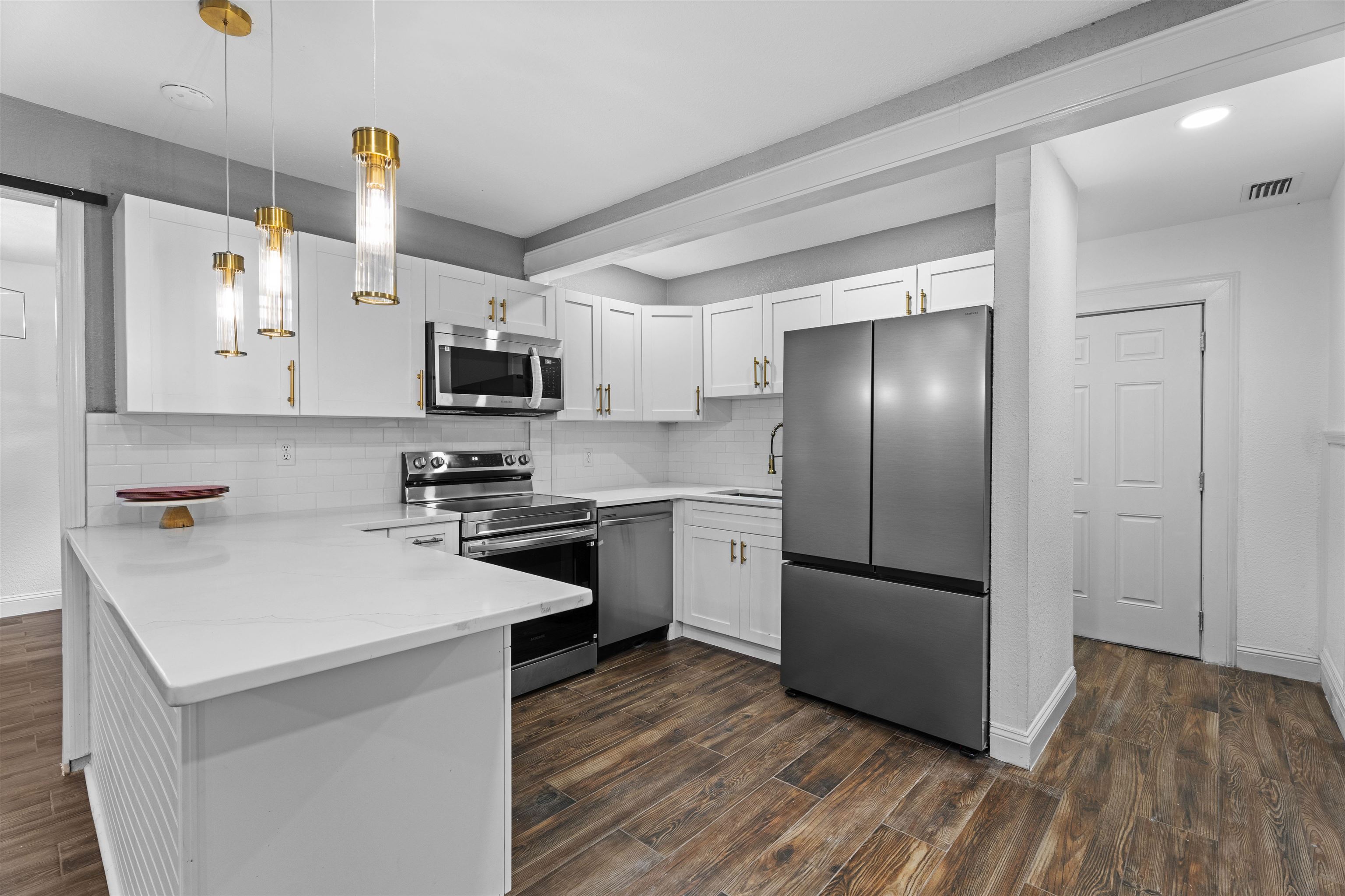 136 Washington Street St. Augustine, FL 32084 - Photo 15 of 50 a kitchen with a refrigerator cabinets and wooden floor