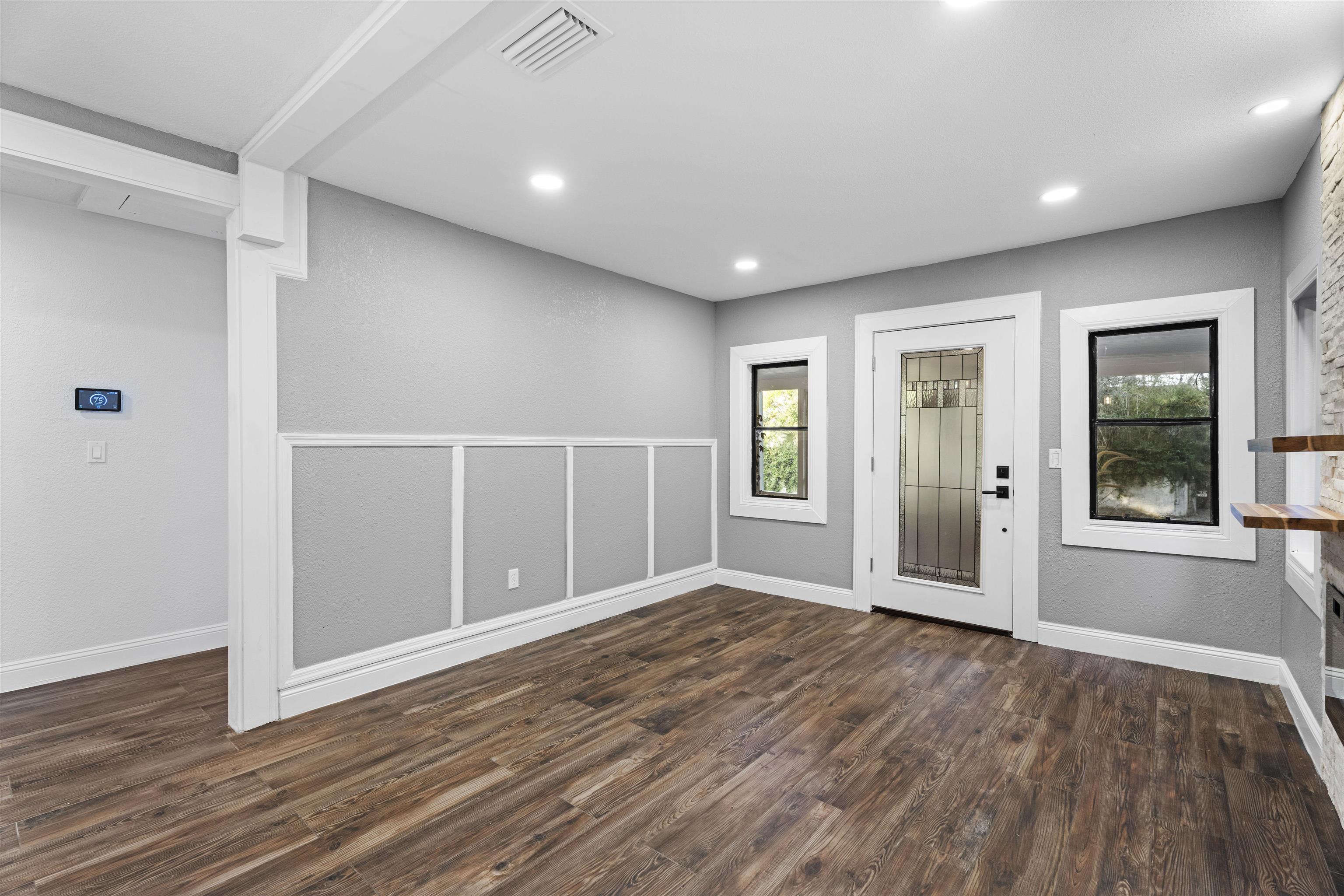 136 Washington Street St. Augustine, FL 32084 - Photo 18 of 50 a view of an empty room with wooden floor and a window