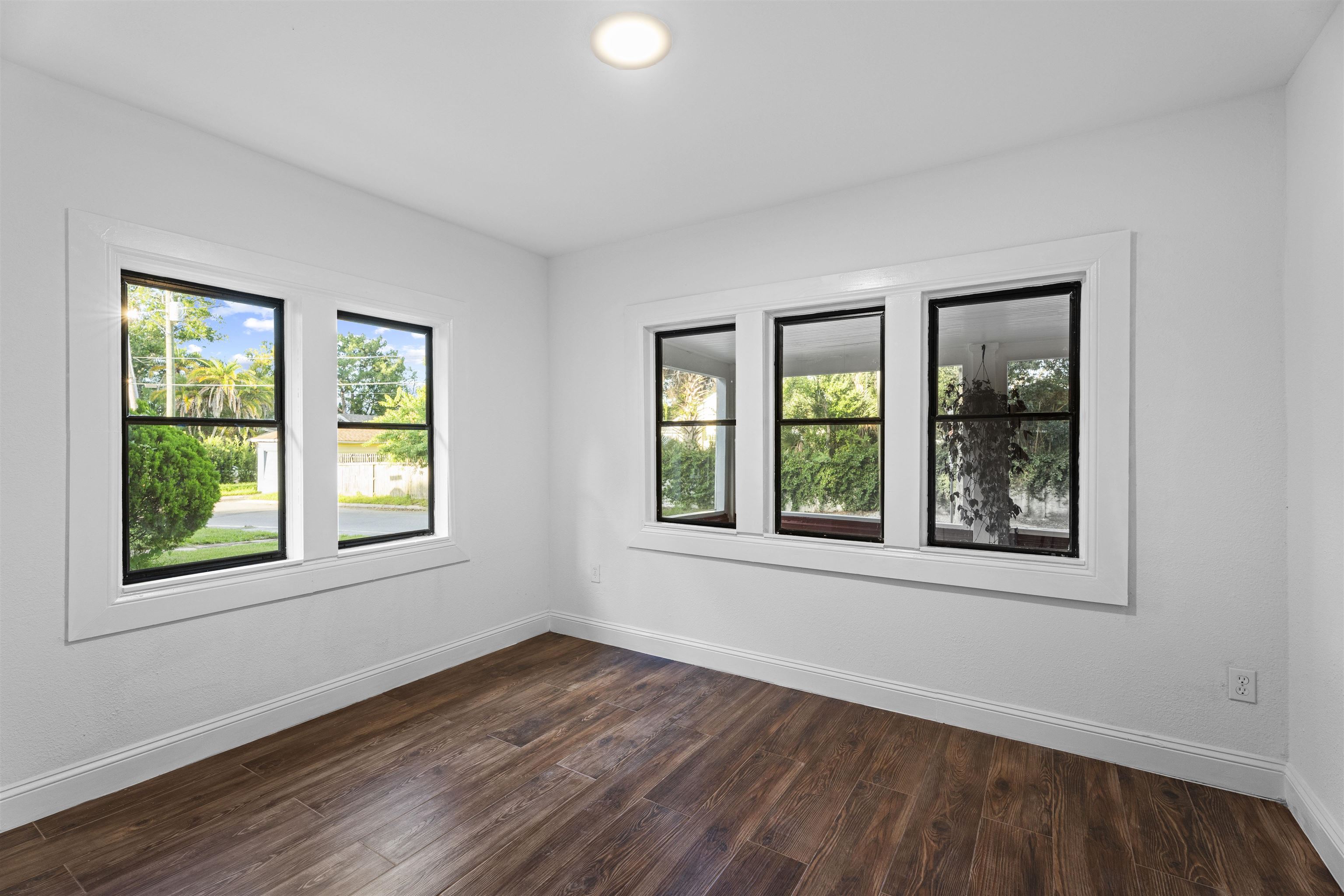 136 Washington Street St. Augustine, FL 32084 - Photo 19 of 50 an empty room with wooden floor and windows