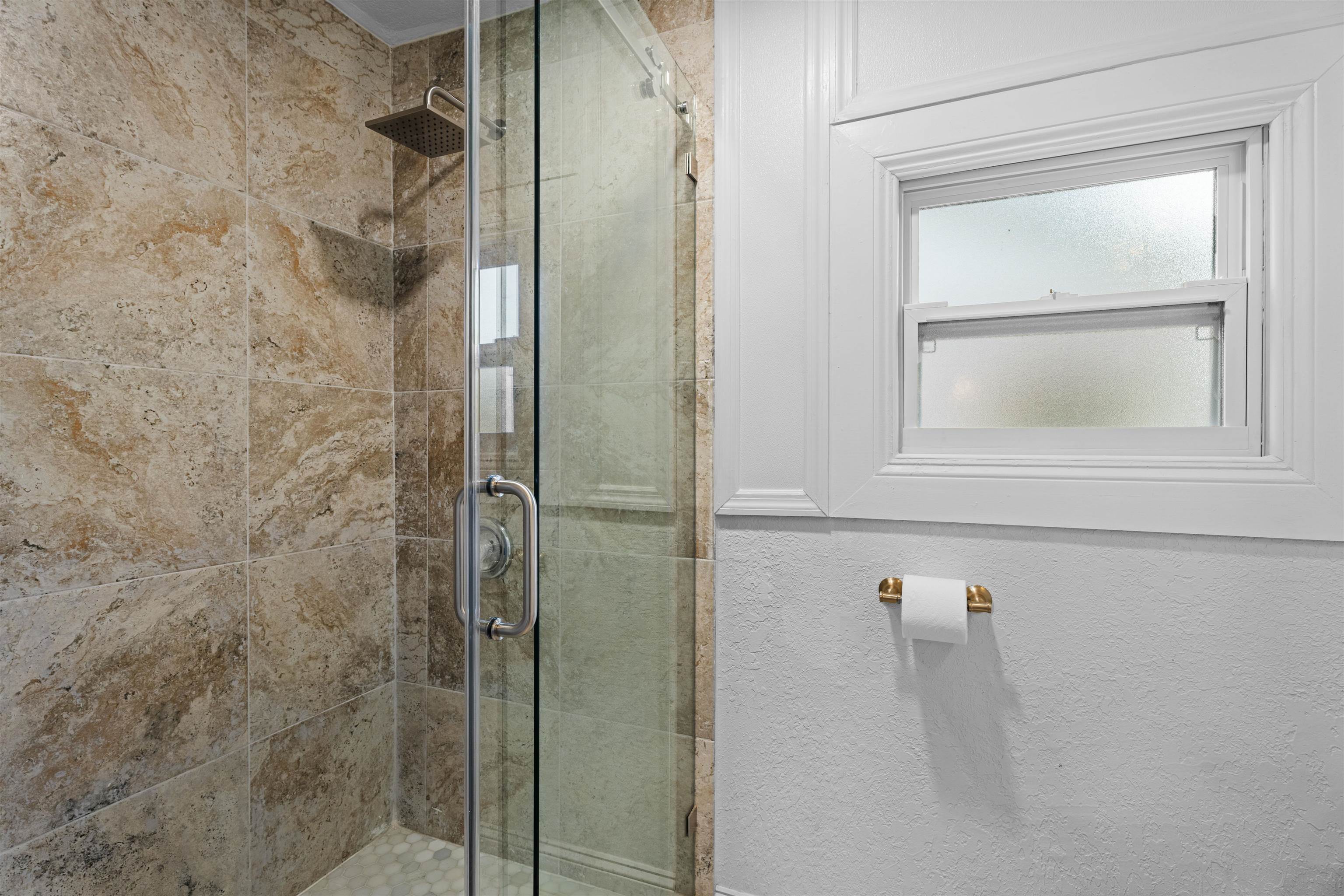 136 Washington Street St. Augustine, FL 32084 - Photo 22 of 50 a bathroom with a glass shower door