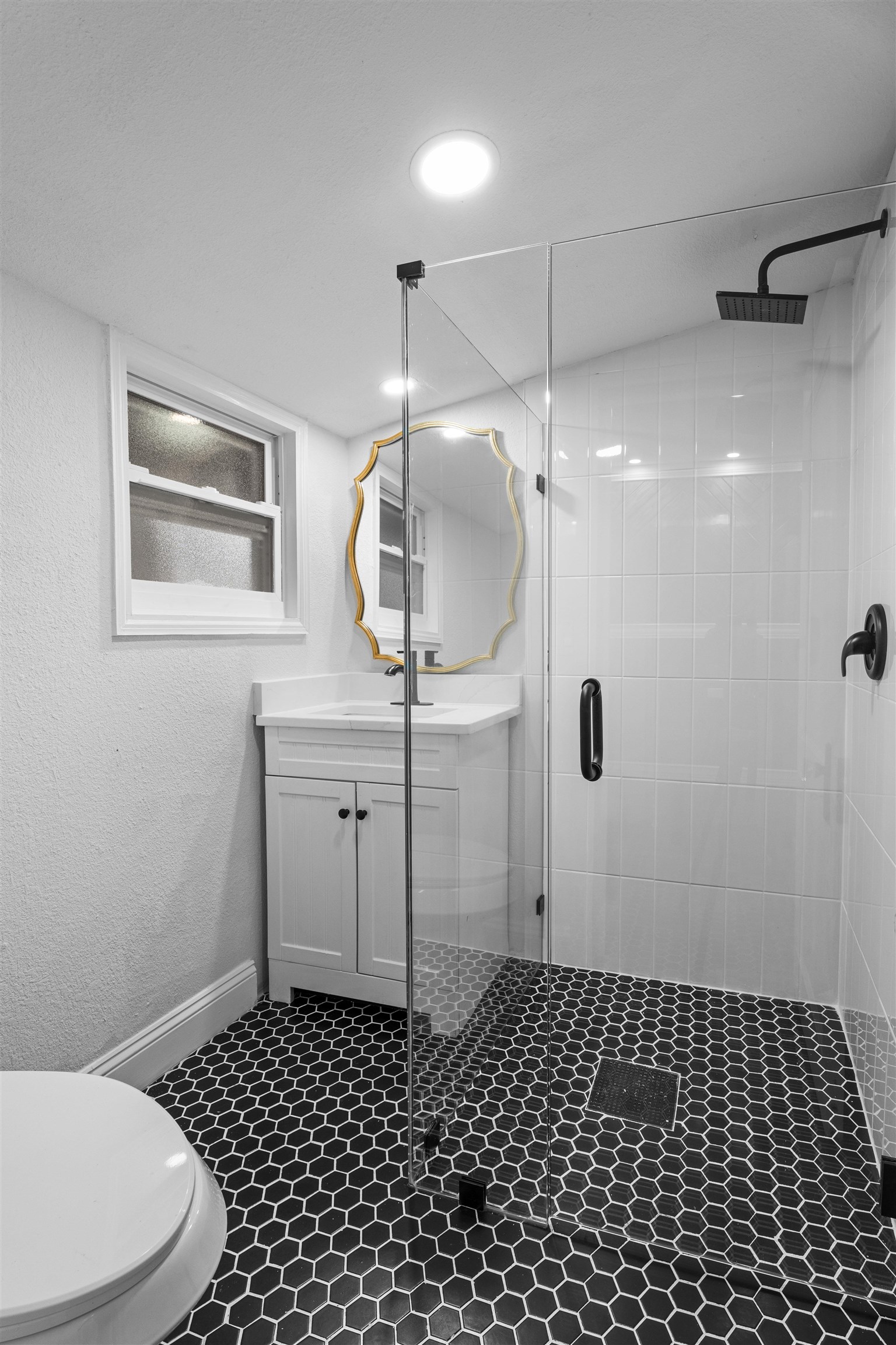 136 Washington Street St. Augustine, FL 32084 - Photo 30 of 50 a bathroom with a sink a toilet and a mirror