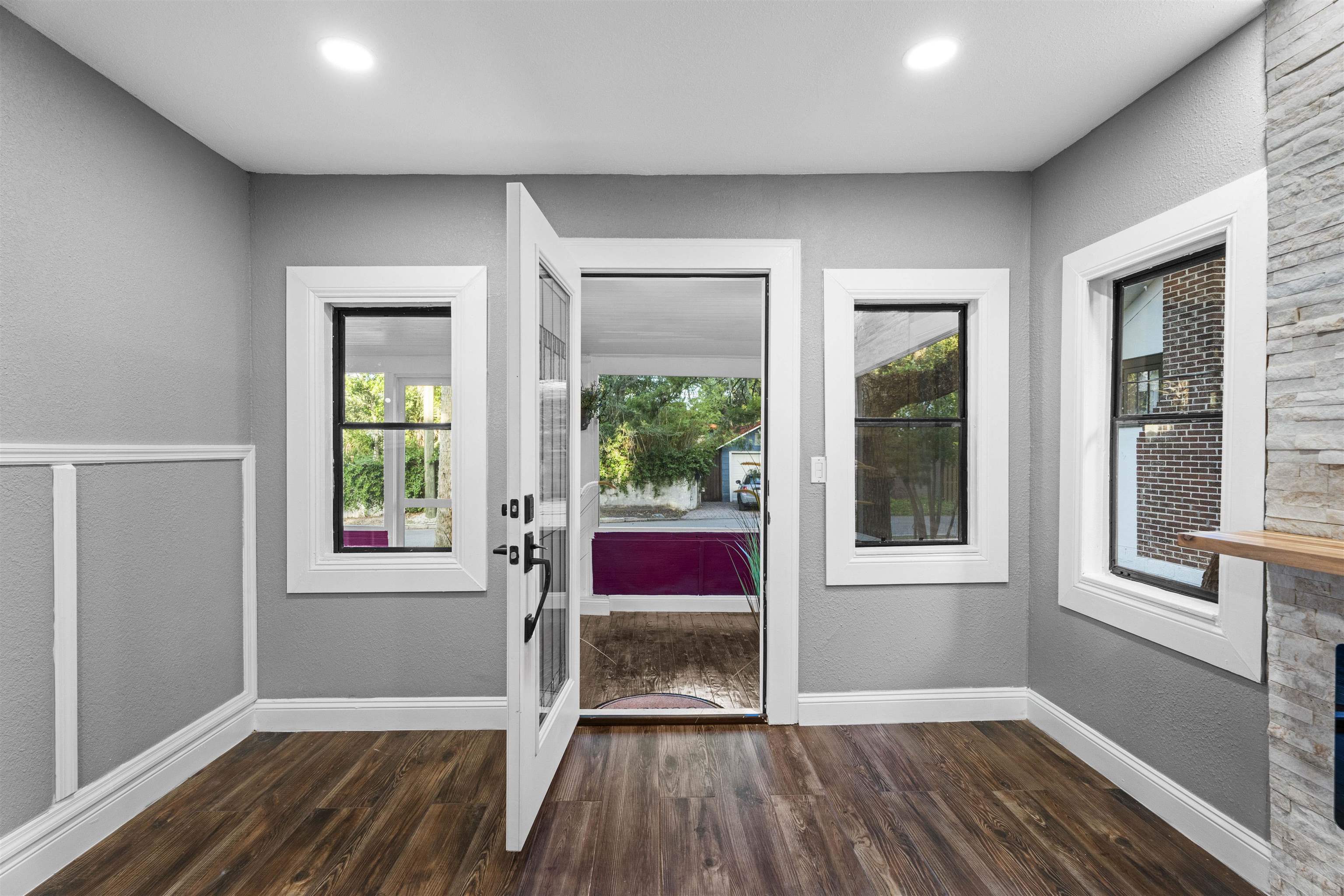 136 Washington Street St. Augustine, FL 32084 - Photo 9 of 50 an empty room with wooden floor and windows