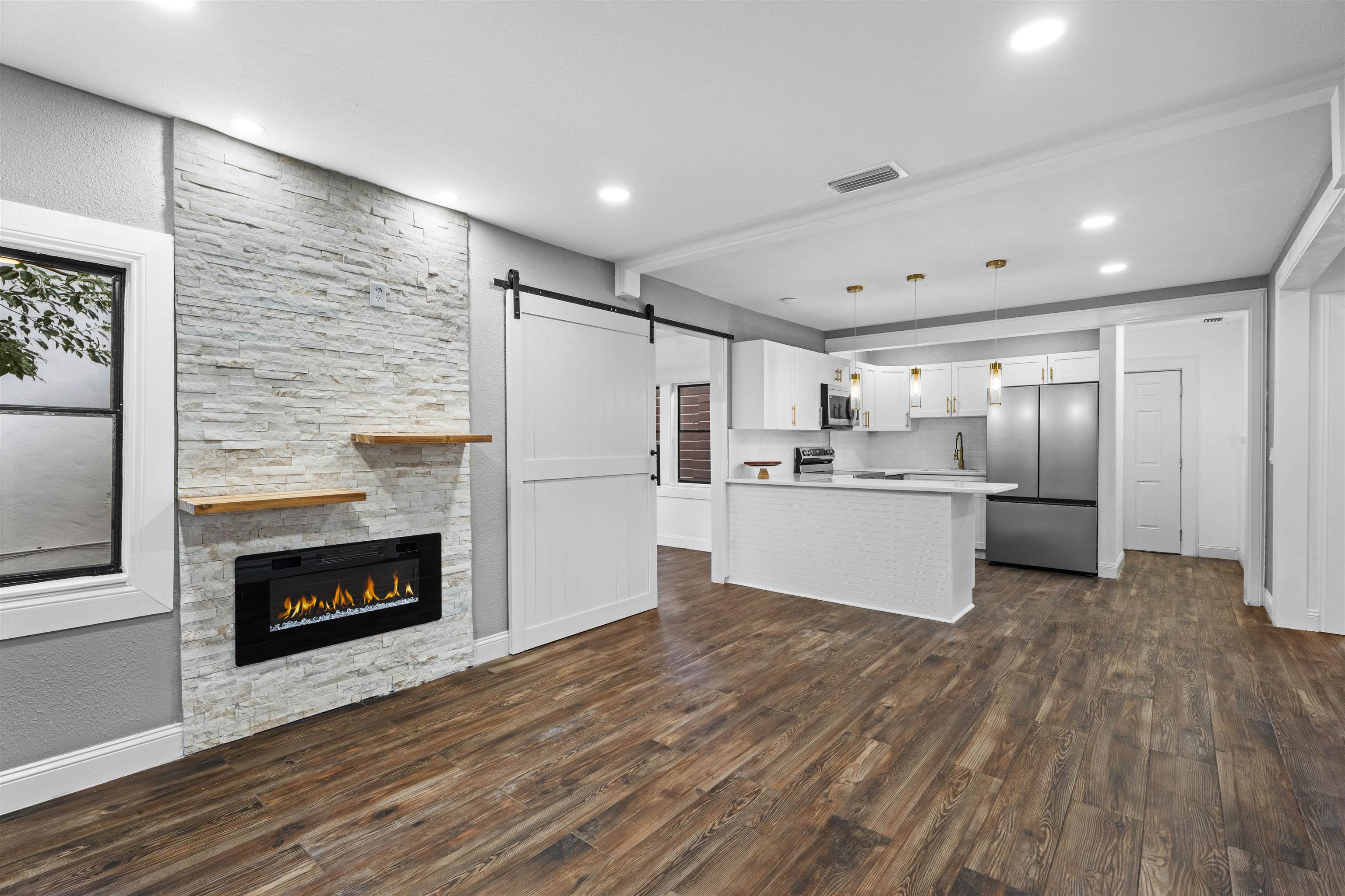 136 Washington Street St. Augustine, FL 32084 - Photo 50 of 50 a large kitchen with a refrigerator a stove top oven and white wooden cabinets