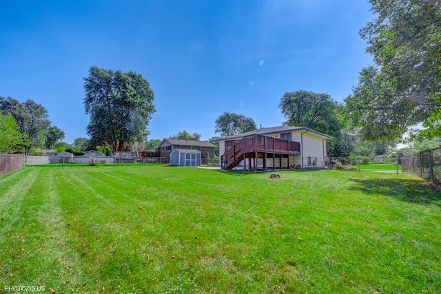 a view of a house with backyard sitting area and garden