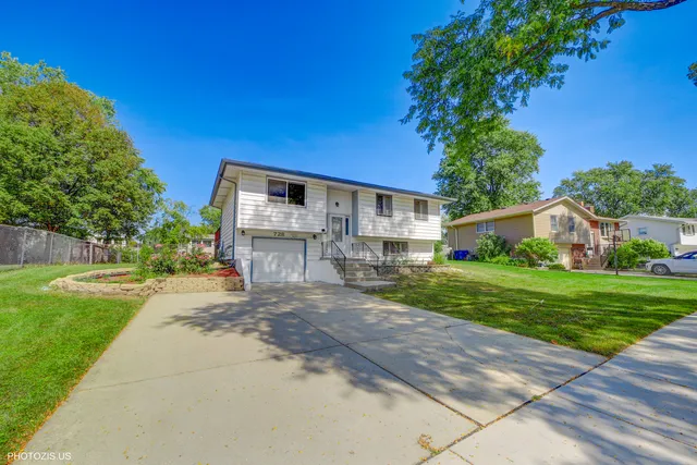 a front view of house with yard and outdoor seating