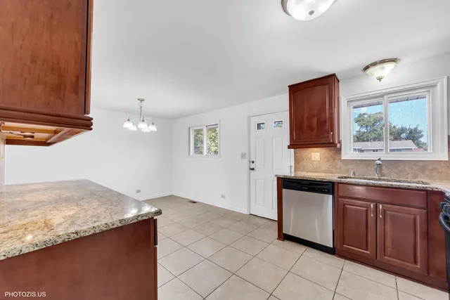 a kitchen with granite countertop a sink and cabinets