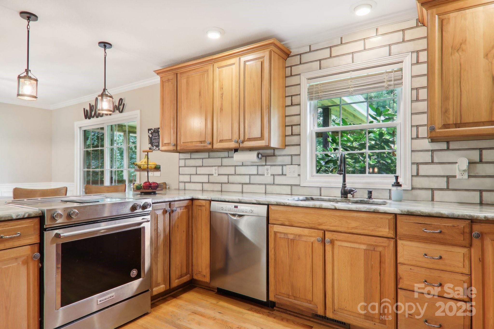 33 Warlick Road Mills River, NC 28759 - Photo 20 of 48 a kitchen with granite countertop cabinets stainless steel appliances a sink and window