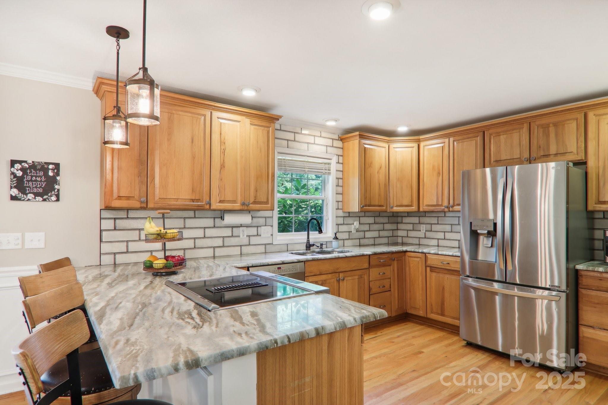33 Warlick Road Mills River, NC 28759 - Photo 21 of 48 a kitchen with stainless steel appliances granite countertop a refrigerator a sink dishwasher a stove and white countertops with wooden floor