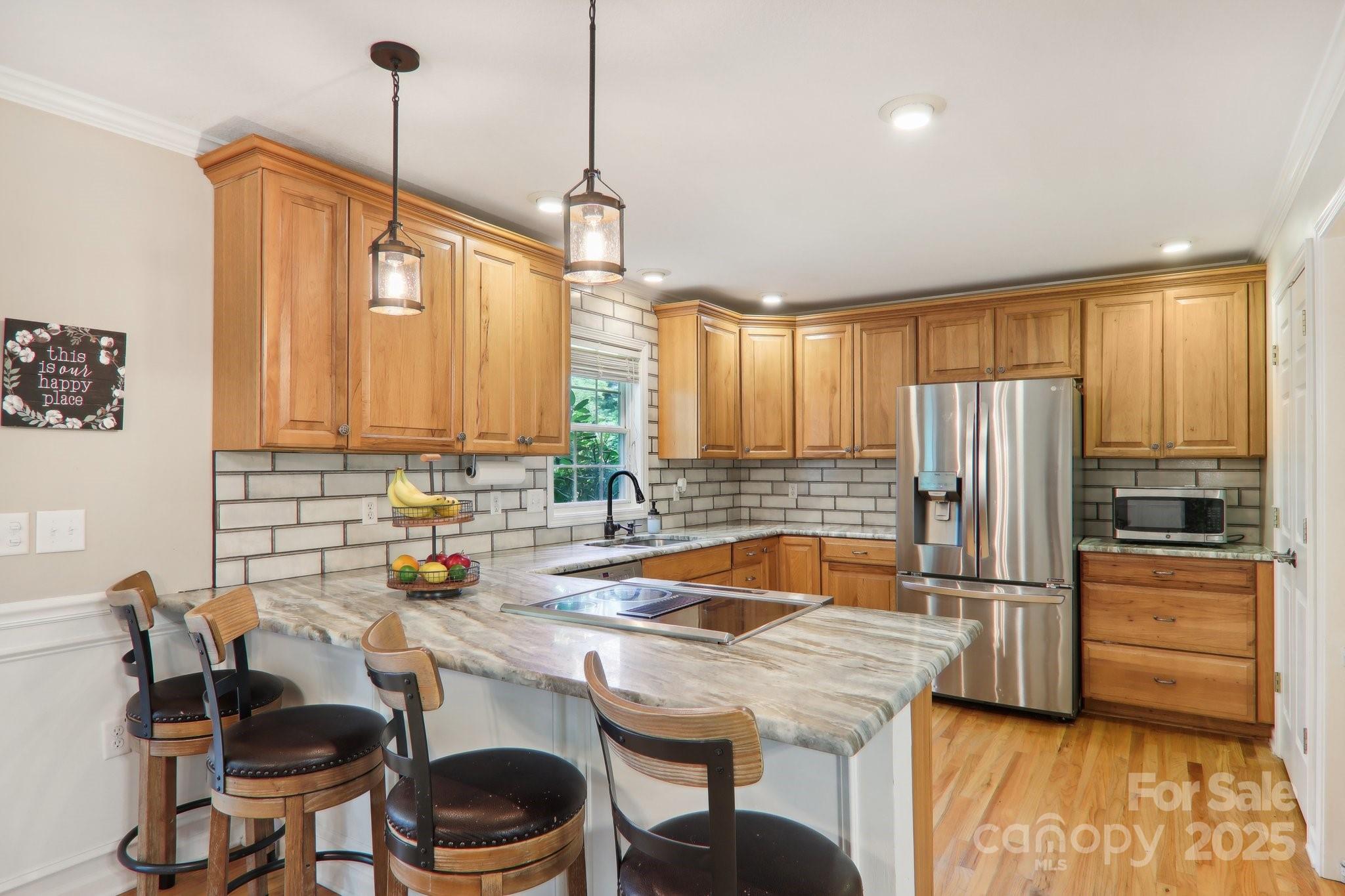 33 Warlick Road Mills River, NC 28759 - Photo 22 of 48 a kitchen with stainless steel appliances granite countertop a sink a stove and a refrigerator