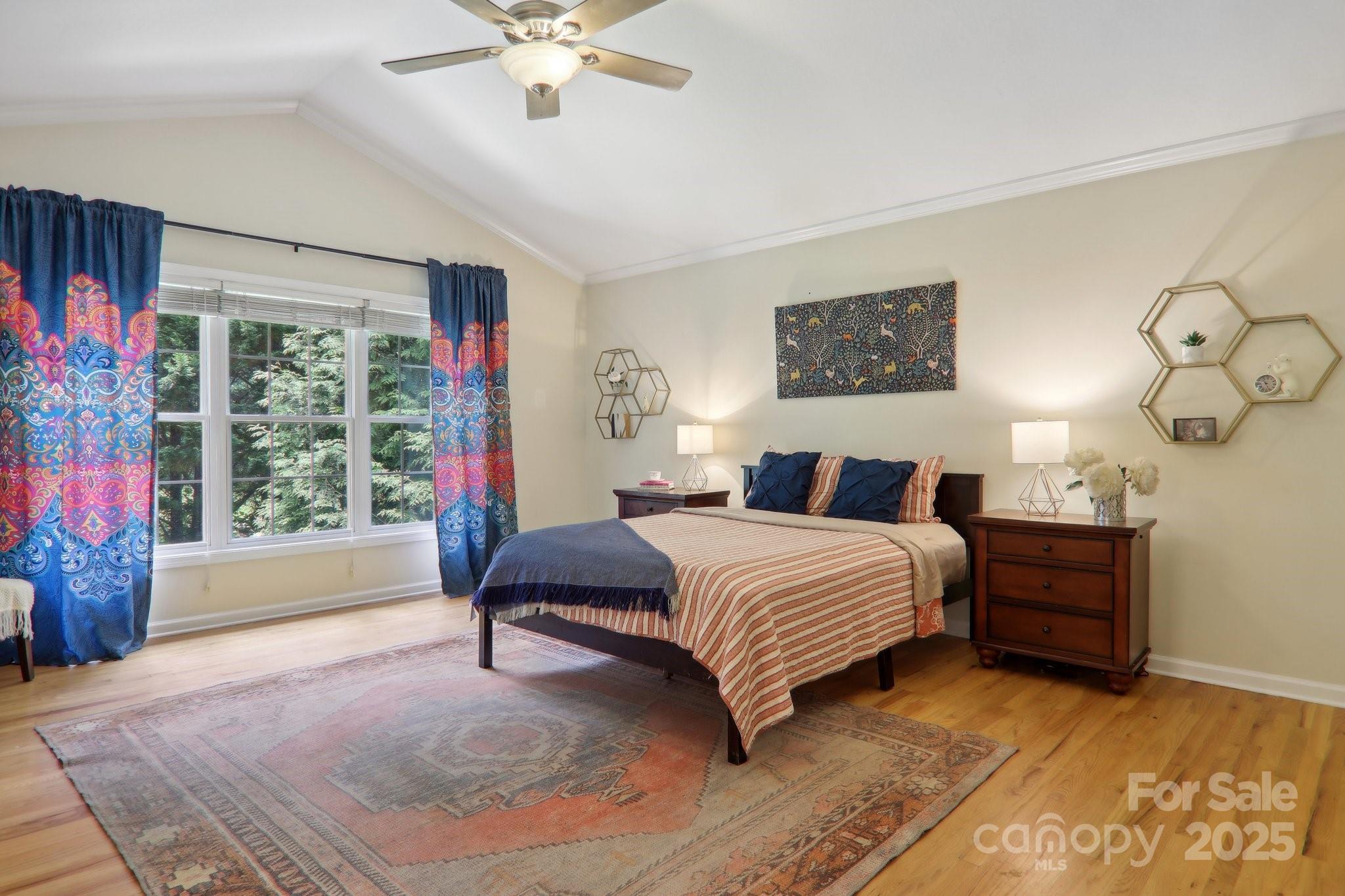 33 Warlick Road Mills River, NC 28759 - Photo 26 of 48 a spacious bedroom with a bed and a chandelier