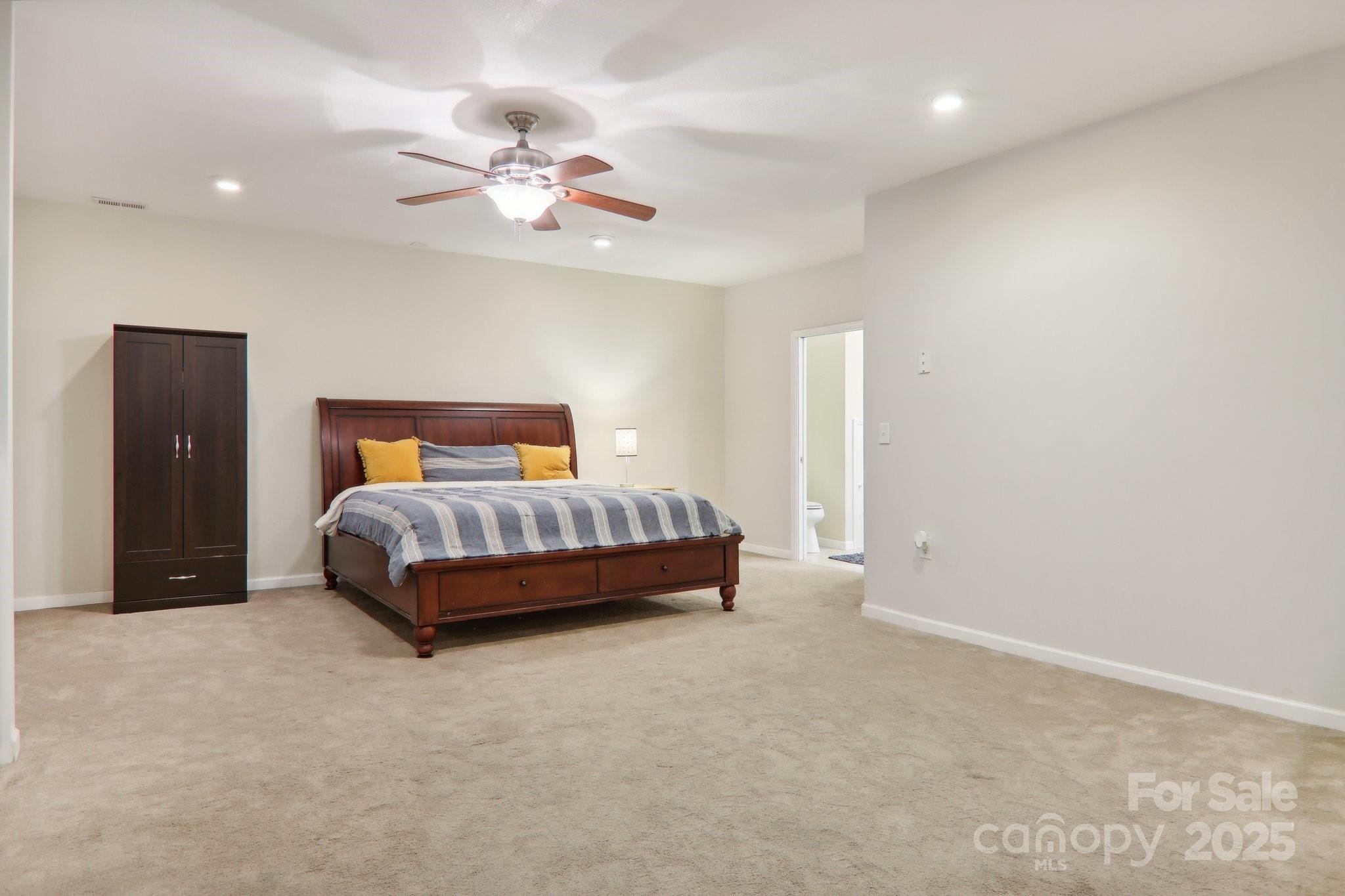 33 Warlick Road Mills River, NC 28759 - Photo 37 of 48 a bedroom with a bed and a chandelier