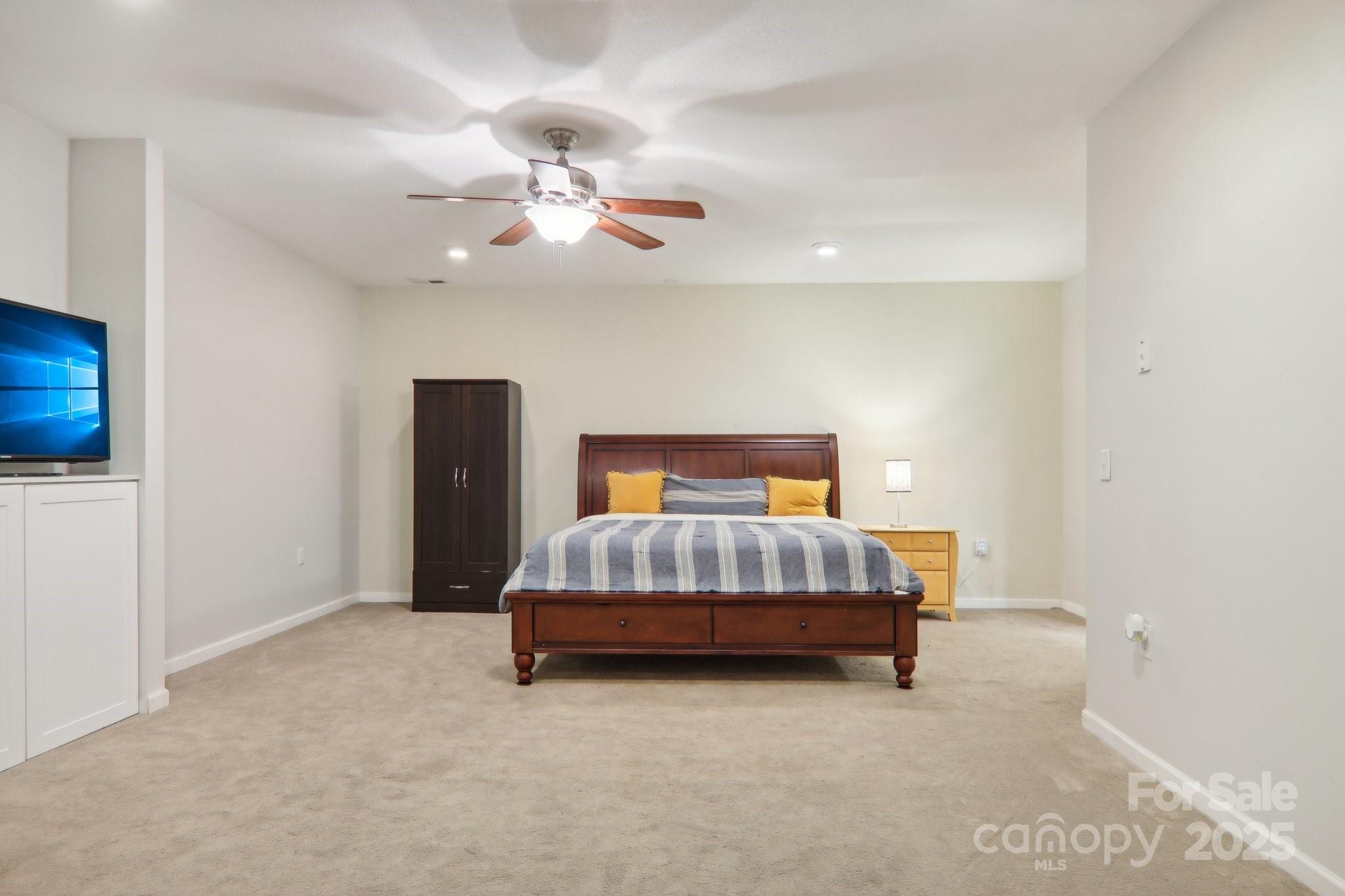 33 Warlick Road Mills River, NC 28759 - Photo 39 of 48 a bedroom with a bed and a chandelier