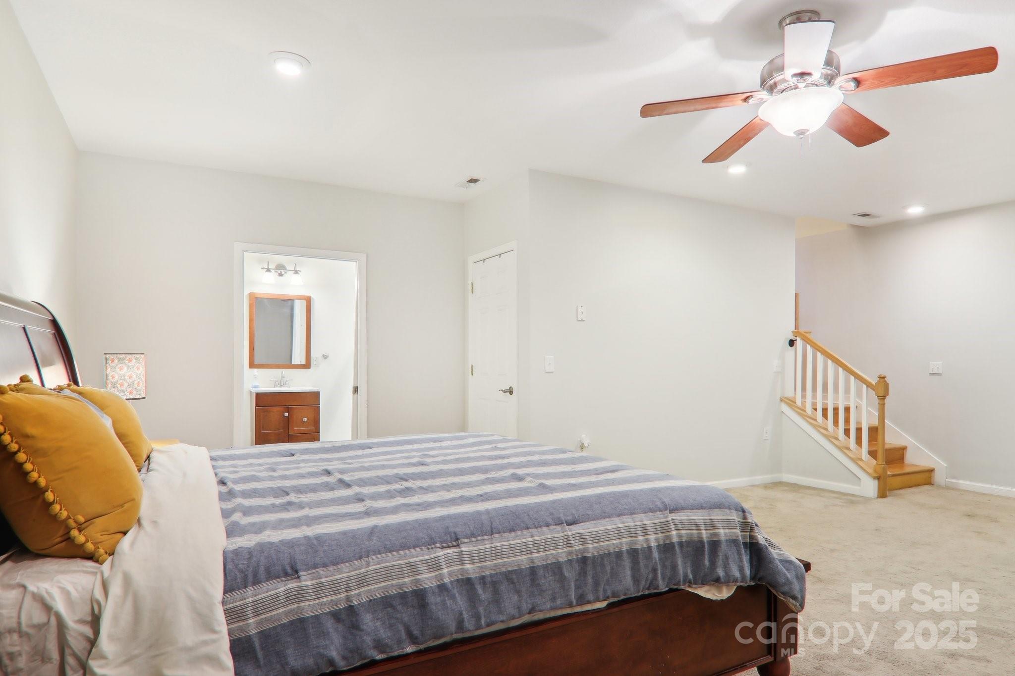 33 Warlick Road Mills River, NC 28759 - Photo 40 of 48 a bedroom with a bed and a chandelier