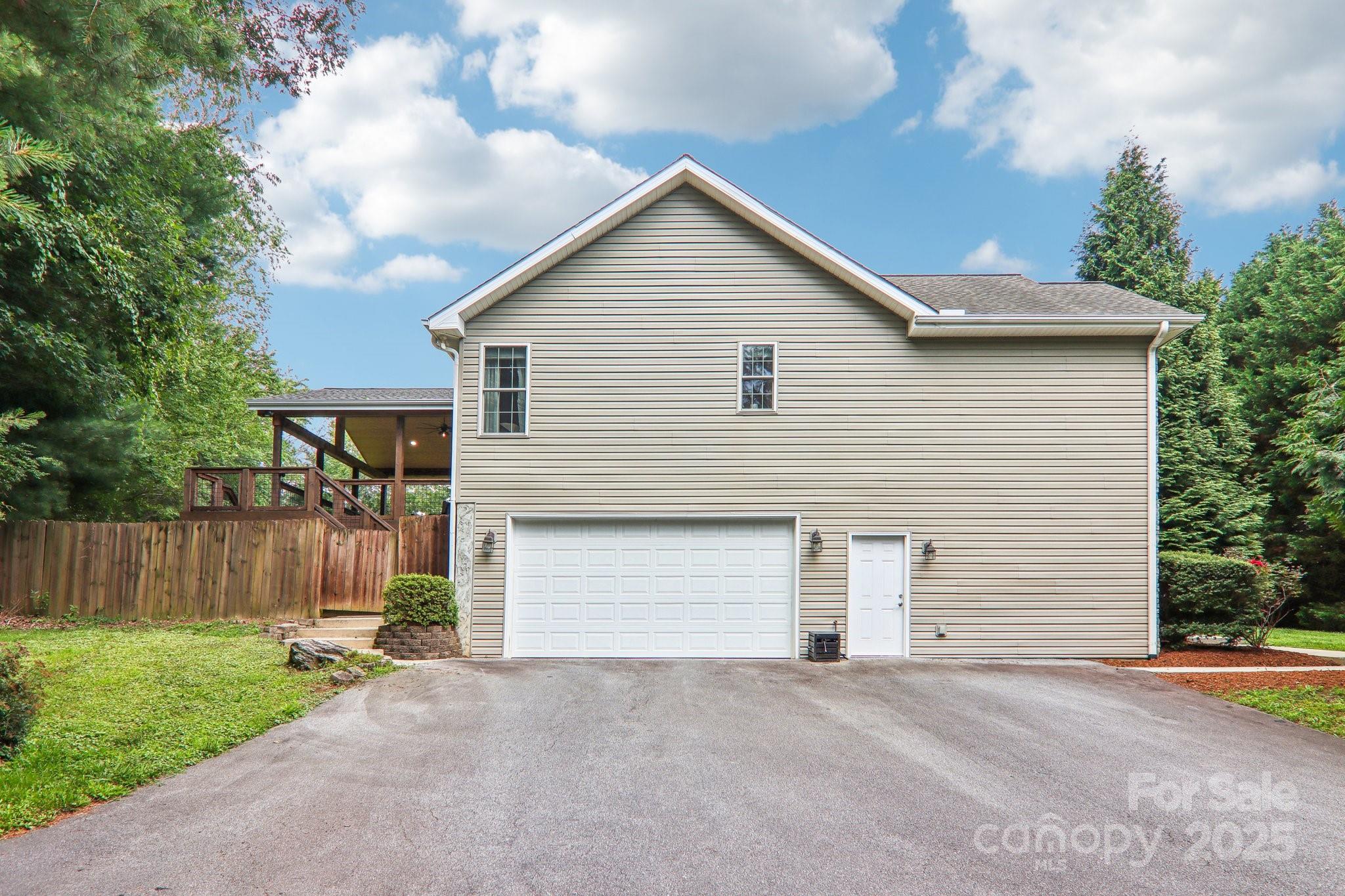 33 Warlick Road Mills River, NC 28759 - Photo 10 of 48 a front view of a house with a yard and garage