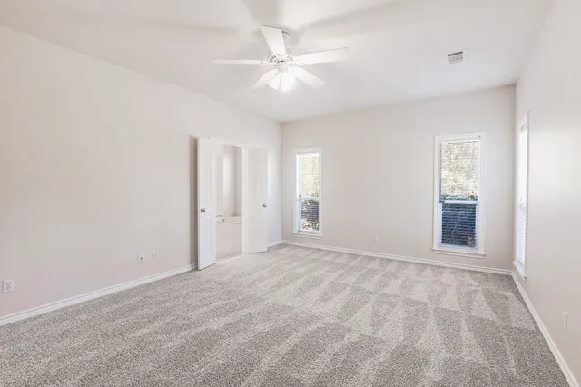 a view of an empty room with a ceiling fan