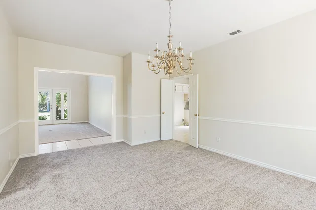 a view of a hallway with a chandelier