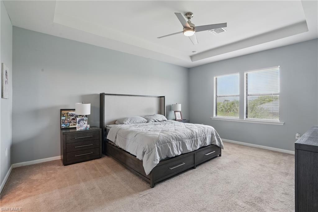 4934 Seton Way Ave Maria, FL 34142 - Photo 17 of 49 a bedroom with a bed and a ceiling fan