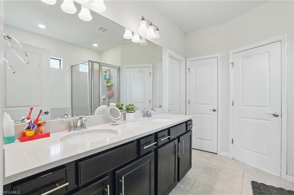 4934 Seton Way Ave Maria, FL 34142 - Photo 20 of 49 a bathroom with a sink double vanity and a mirror