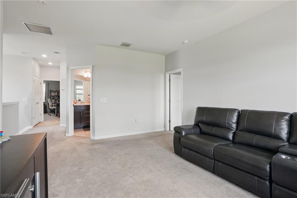 4934 Seton Way Ave Maria, FL 34142 - Photo 23 of 49 a living room with furniture and a couch