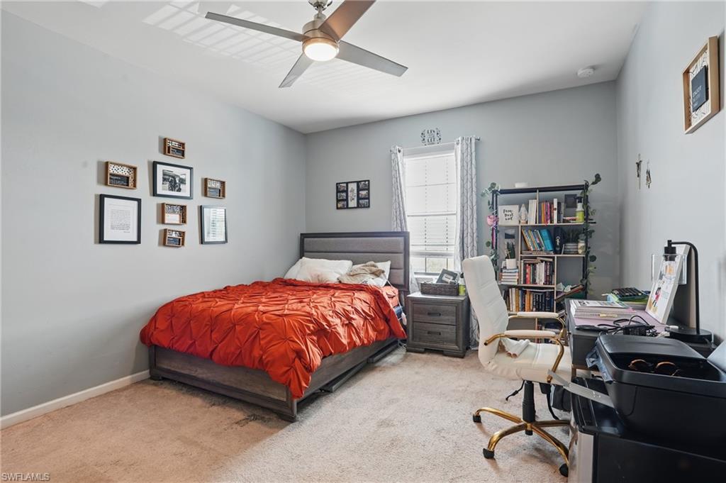 4934 Seton Way Ave Maria, FL 34142 - Photo 26 of 49 a bedroom with bed and a bookshelf