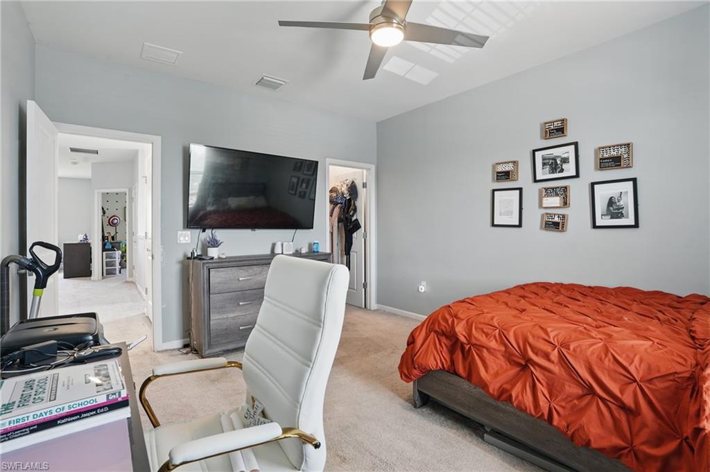 4934 Seton Way Ave Maria, FL 34142 - Photo 27 of 49 a bedroom with a bed and a flat screen tv
