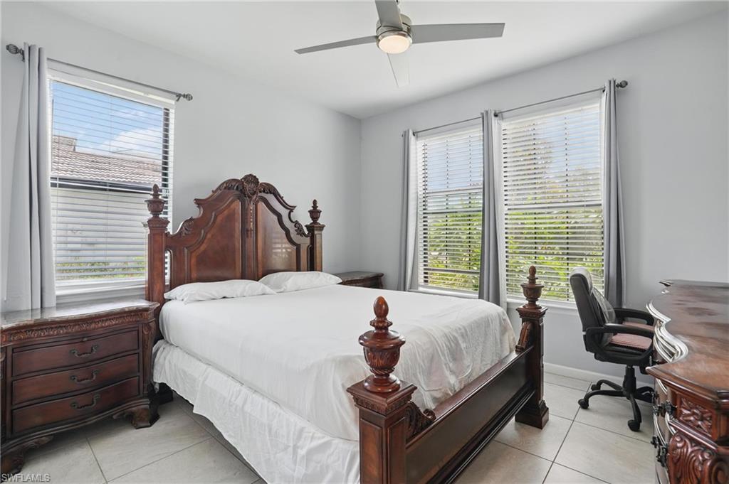 4934 Seton Way Ave Maria, FL 34142 - Photo 28 of 49 a bedroom with a bed and windows