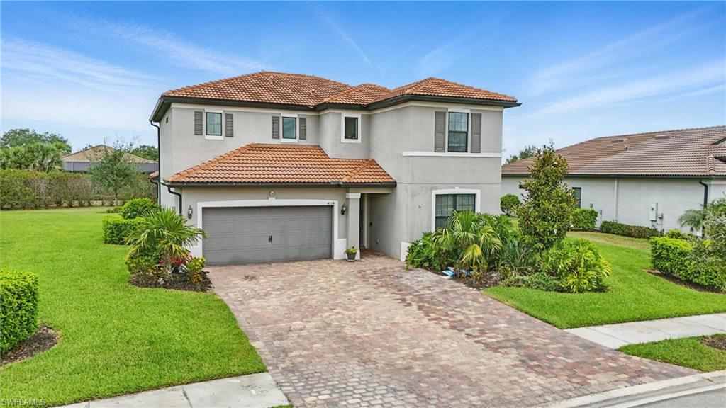 4934 Seton Way Ave Maria, FL 34142 - Photo 37 of 49 a front view of a house with a yard and garage