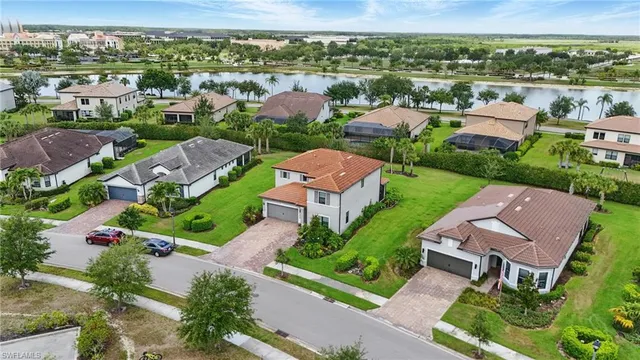 an aerial view of a house with a garden and lake view