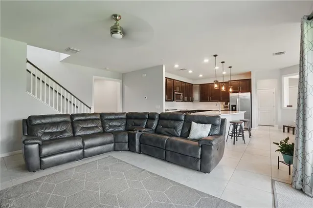 a living room with furniture and a dining table