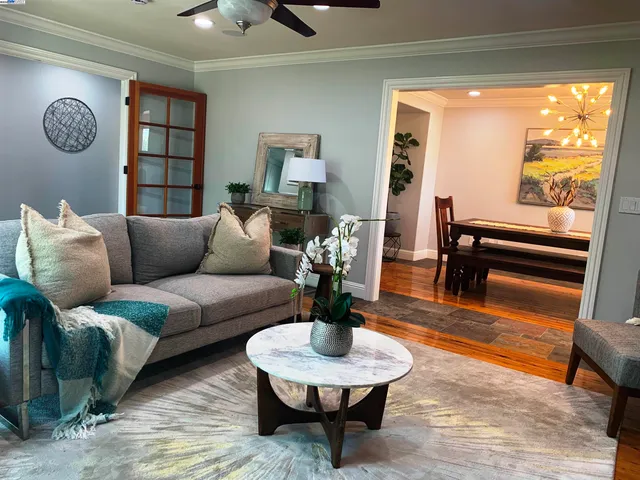 a living room with furniture rug and window