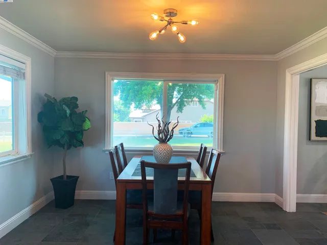 a view of a hallway with wooden floor and a living room