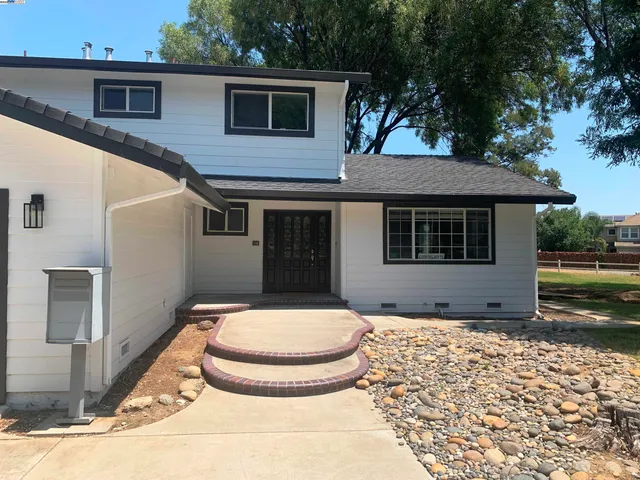 a front view of a house with a garden