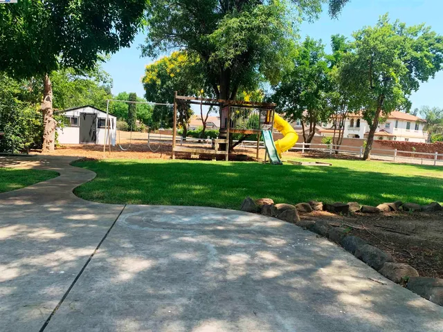 a house view with a sitting space and garden